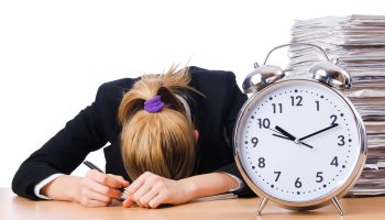 Woman businesswoman with giant alarm clock